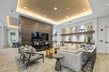 A living room with a white couch and a television